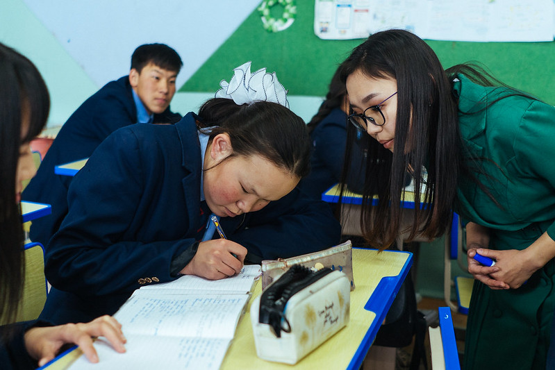 Oyunjargal concentrates during a language lesson while teacher Narantuya Batjil observes her work. Murun, Mongolia. Credit: GPE/Bat-Orgil Battulga