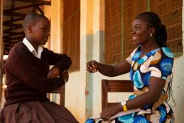 CAMFED Learner Guide Sophia Leonard speaks with secondary student, Hanipha, at her school in Kilosa, Tanzania. Credit: CAMFED/Eliza Powell