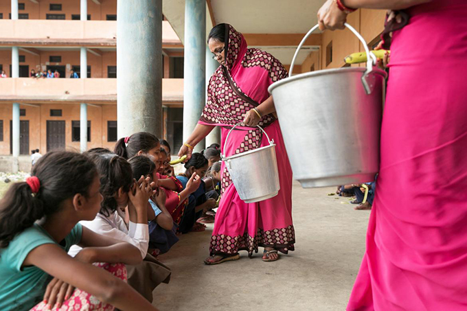 Children recieve snacks at school Nepal Photo Kelley Lynch 680x453