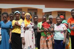 Headteacher Ms Nakayiza Amina of Kisimba Umea primary school with a group of girls who left school  because they were pregnant. However, they were able to return to school to sit their exams. Some of the girls are now mothers; others lost their babies due to miscarriages. 